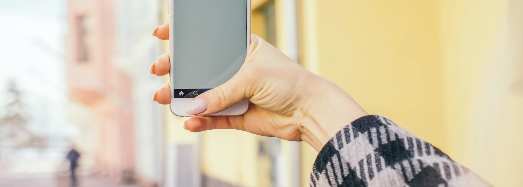 A woman uses her smartphone outdoors