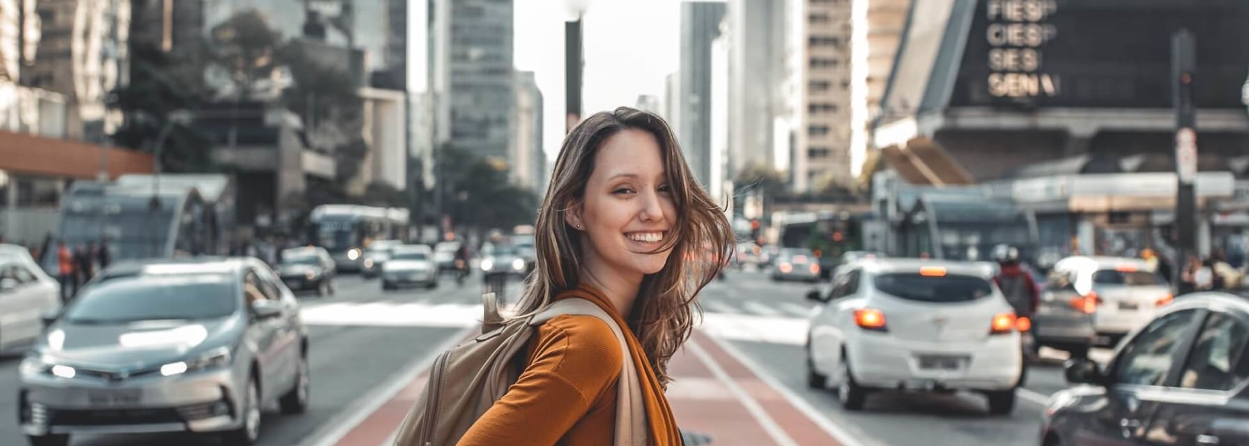 a woman crosses the street