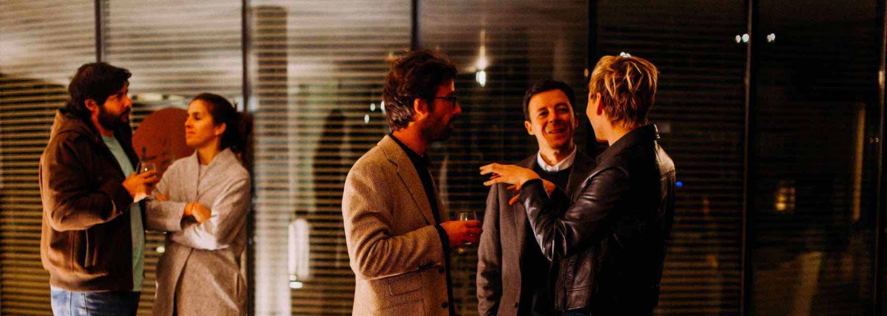 people mingle before a dinner party