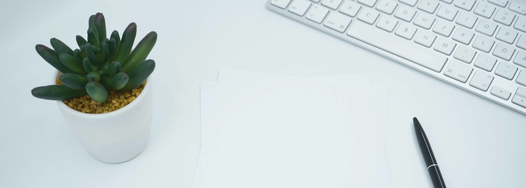 documents on a desk next to a keyboard