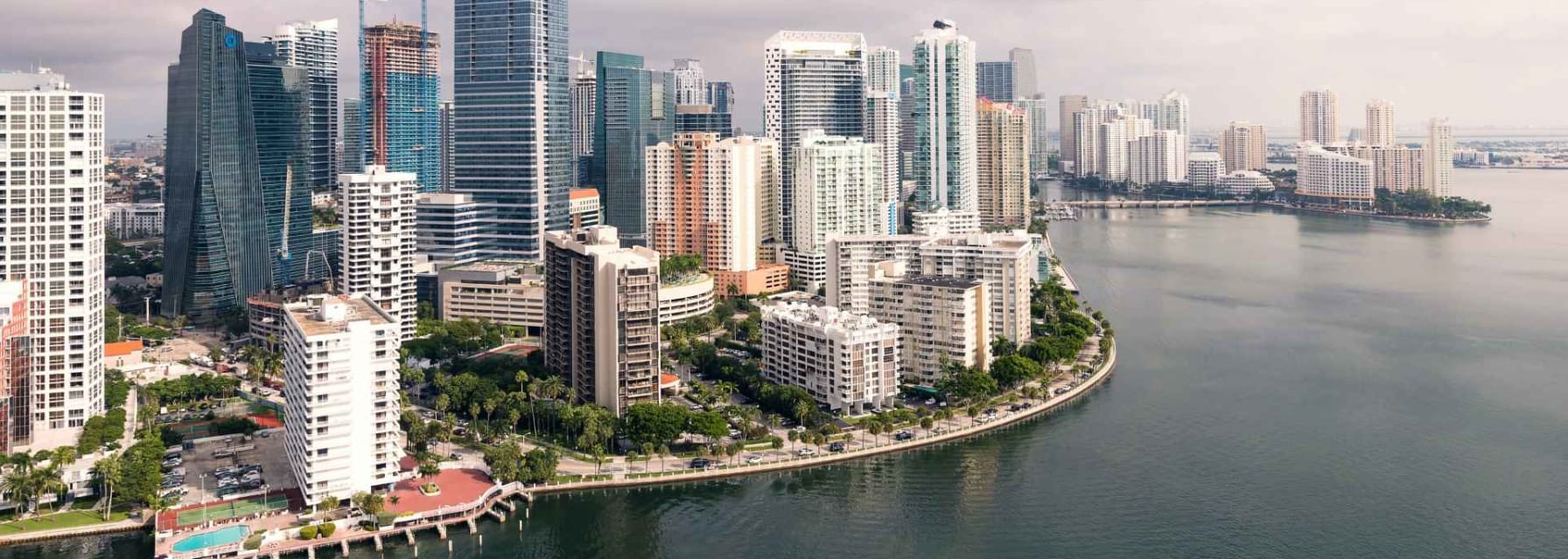 An aerial view of downtown miami. Skyscrapers are seen near the city waterfront.