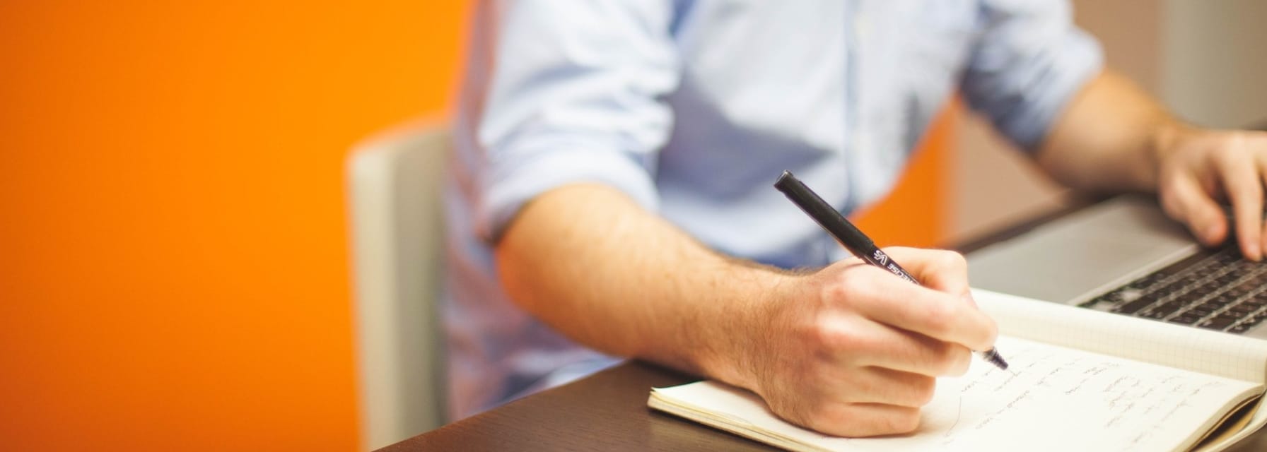 Man writing in notebook