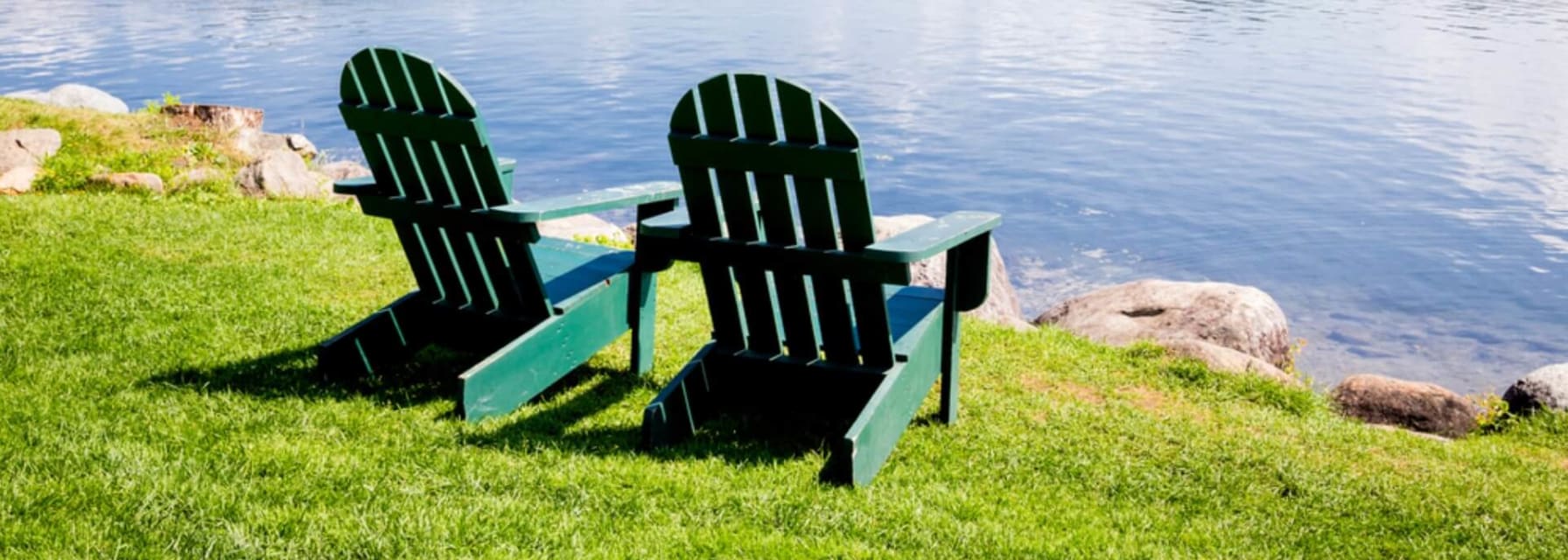 two chairs facing the calm lake