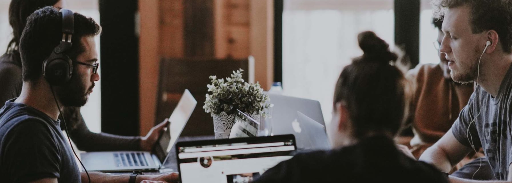 People sitting in the table of a co-working space and working on their laptops