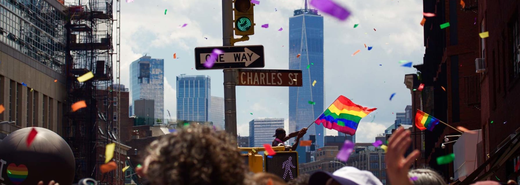 People marching down a street in new york for a pride parade.