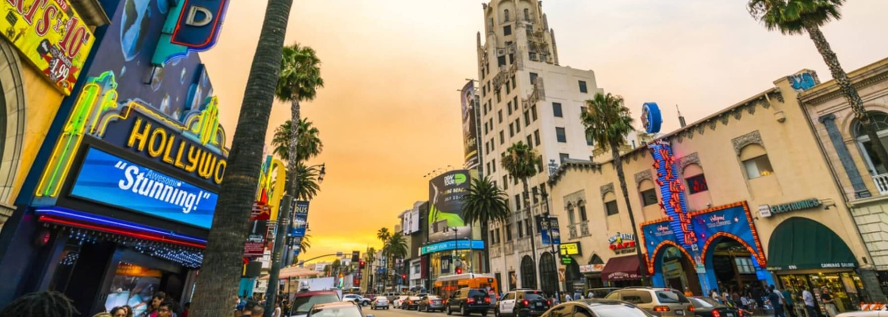 Hollywood Californi at sunset with an orange sky above buildings and lights