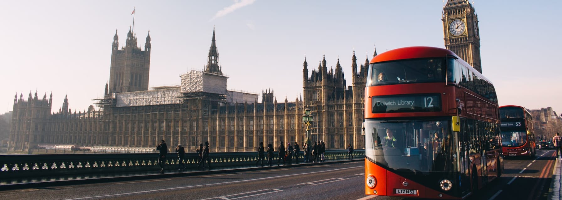 Busy street in London with a red bus and the Big Ben in the background