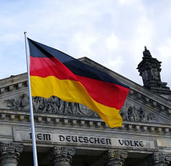 German flag in front of the Reichstag building in Berlin