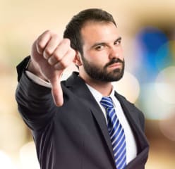 Man in suit with thumb pointing down