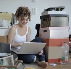 Woman sitting in messy room