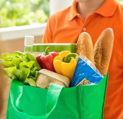 Person delivering groceries in a bag