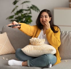 Woman watching TV with popcorn