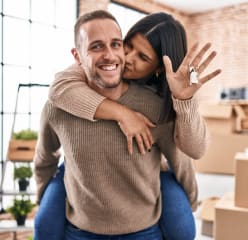 Couple kissing while holding house keys