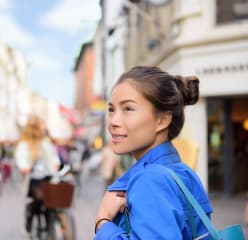 Woman on a European street looking around