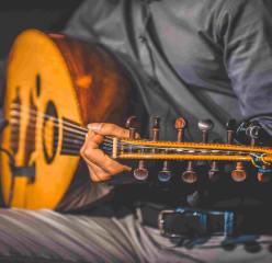 A man holding a traditional string instrument.