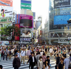 People walking across street in Tokyo