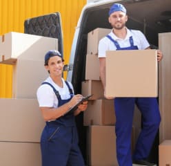 two men working for a Chicago moving company taking boxes from the moving van