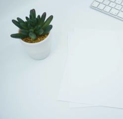 documents on a desk next to a keyboard