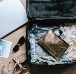 a packed suitcase with a few items to add