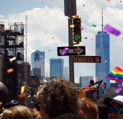 People marching down a street in new york for a pride parade.