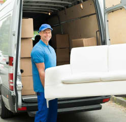 Furniture donation DC and two movers carrying a couch to a van