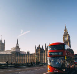 Busy street in London with a red bus and the Big Ben in the background