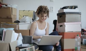 Woman sitting in messy room