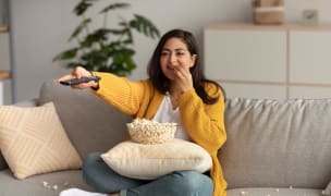Woman watching TV with popcorn
