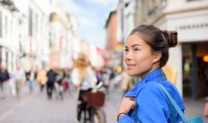Woman on a European street looking around