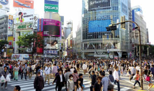 People walking across street in Tokyo