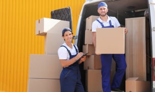 two men working for a Chicago moving company taking boxes from the moving van