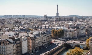 the paris skyline on a cloudy day with the eiffel tower in the background