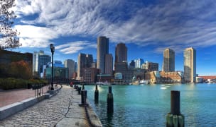the boston harbor and skyline with clouds overhead