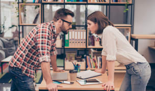 Man vs woman. Two concentrated business partners quarreling.