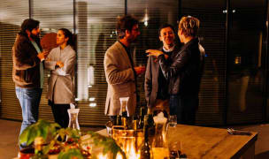 people mingle before a dinner party