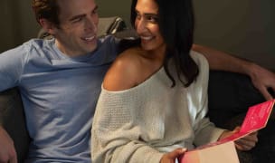 a couple sits together at home