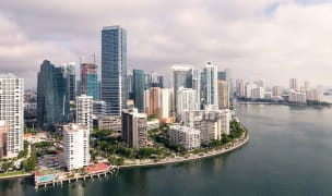 An aerial view of downtown miami. Skyscrapers are seen near the city waterfront.