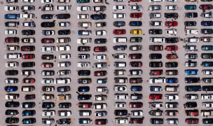 aerial shot of a car park filled with vehicles parallel parked in rows