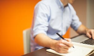 Man writing in notebook