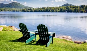 two chairs facing the calm lake