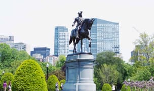An image of a statue in the middle of a park in Boston.