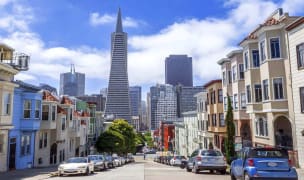 cars parked on the streets of a San Francisco neighborhood with views of the financial district