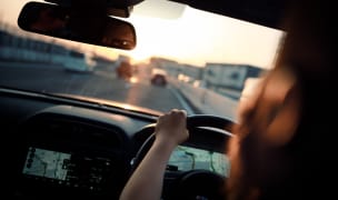 Photo of a man driving from inside the car.
