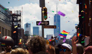 People marching down a street in new york for a pride parade.