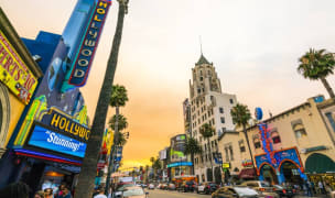 Hollywood Californi at sunset with an orange sky above buildings and lights