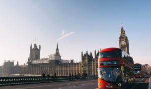 Busy street in London with a red bus and the Big Ben in the background