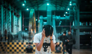 man is reacting to a loud noise by closing his ears