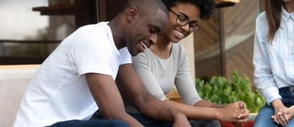 couple smiling while signing a lease agreement