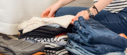 woman folding clothes for travel