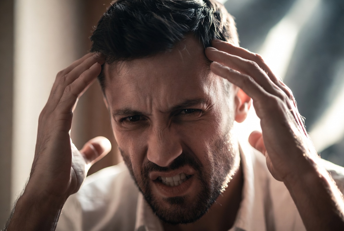 The man looks highly stressed